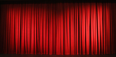 Beautiful full length luxurious traditional red burgandy stage curtains on a theatre stage with...