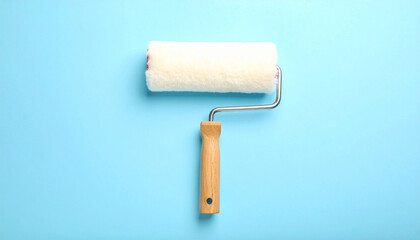 Fototapeta premium Painter's Tool on Blue: A close-up studio shot showcases a paint roller poised against a vivid blue surface. The image conveys tools used for home improvement. 
