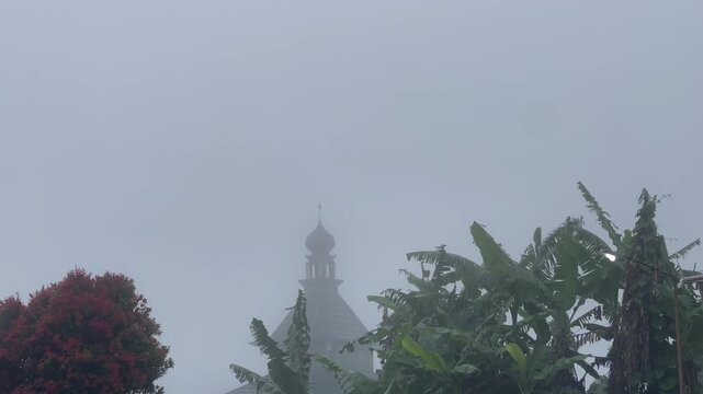 The mosque minaret was covered in thick fog