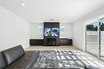 Modern living room with marble fireplace.