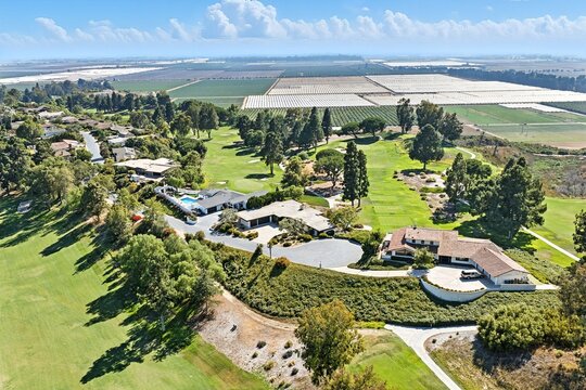 Aerial view of golf course and homes.