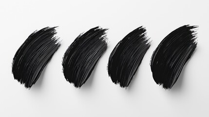 Four brush strokes of black ink on white background