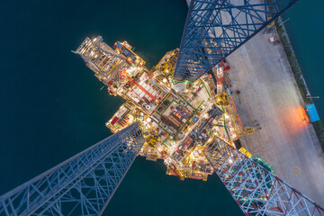 Aerial top view of offshore jack up rig and offshore platform during sunset for oil and gas...