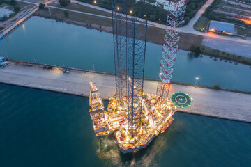 Aerial top view of offshore jack up rig and offshore platform during sunset for oil and gas...