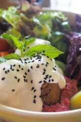 Delicious salad bowl with rich dressing and herbs
