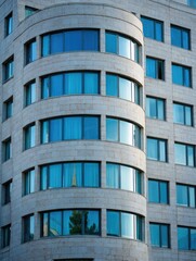 Modern building facade with curved sections and numerous windows