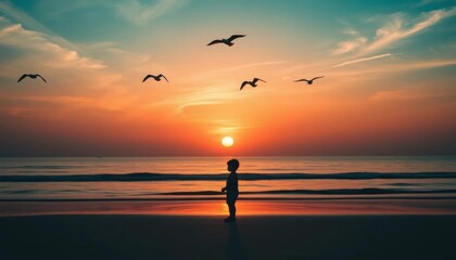 Fototapeta premium Sunset silhouette of childlike figure on beach, birds flying overhead, beach, horizon