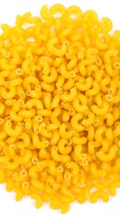 A close-up overhead shot of a pile of dried elbow macaroni