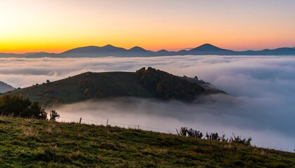 Obraz premium Sunrise over a valley shrouded in mist