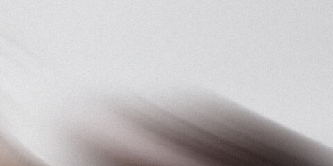 A textured abstract background with a gradient of light and dark gray colors creating a dynamic and blurred motion effect