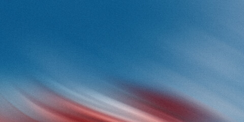 A vibrant sunset sky displays a blurred motion of red and blue, creating an abstract and atmospheric background