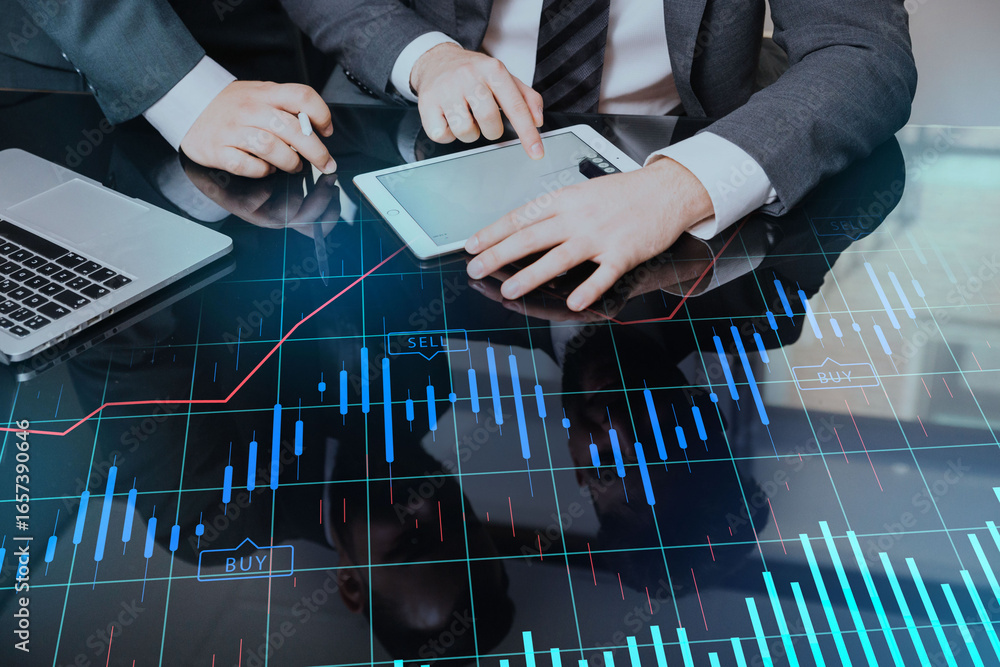 Aufkleber two professionals collaborating over a digital tablet displaying financial data and charts.