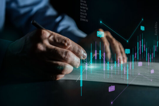 Hands analyzing financial data with glowing charts and graphs on a dark background.