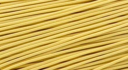 Close-up of Raw Spaghetti Noodles: Golden Yellow Texture and Culinary Ingredient