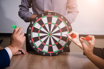 Business team pointing to a darts aiming at the target center business,Targeting the business...