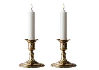 Two brass candle holders, white candles