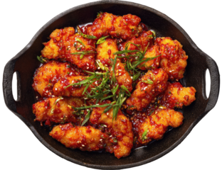 Crispy, spicy chicken pieces in a dark skillet