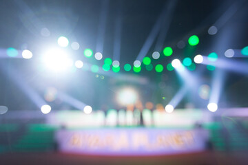 blurred background of event concert or award ceremony with lighting at conference hall