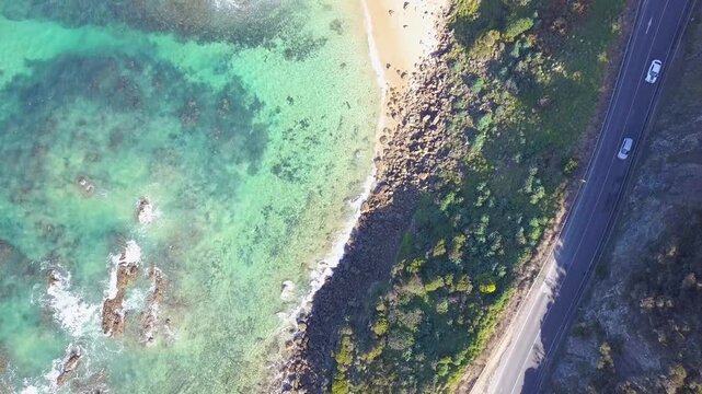 Drone footage of the Great Ocean Road in Victoria, highlighting rugged cliffs, blue ocean waves, and green forest along Australia&rsquo;s famous coastal drive - DLOG Flat File 4K