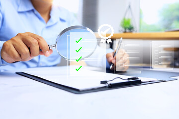 audit concept with auditor holding magnifying glass to checkout document record for ISO assessment activity process