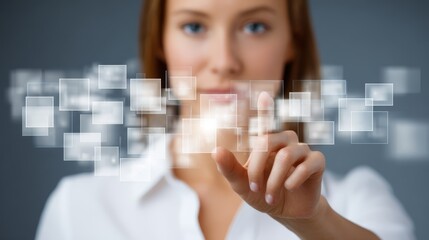 Close up of a female hand with manicured nails interacting with a modern digital interface pressing a glowing blue virtual button on a futuristic transparent touch screen display.