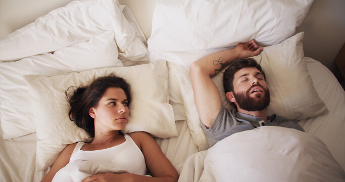 Couple, bed and woman annoyed with man for snoring, loud or noise with frustrated partner in home. Person with sleep apnea, angry wife with sleepless night and awake, upset and irritated at house