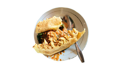 Indonesian pecel rice with crispy peanut crackers, served on an Asian-style plate. A perfect...