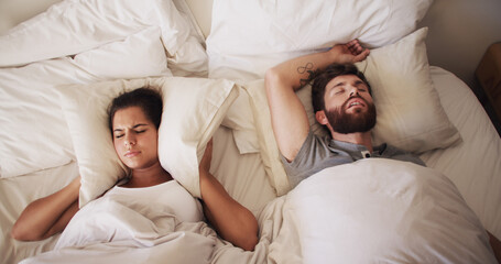 Couple, bed and woman with man snoring, loud or noise with frustrated partner in home. Person with sleep apnea, above angry or annoyed wife for sleepless and awake, upset and cover ears at house