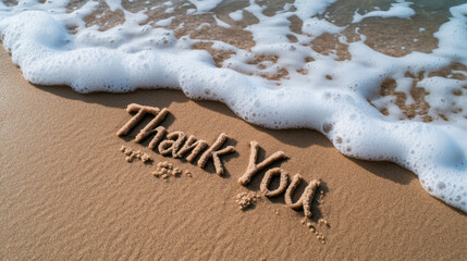 Message of Gratitude Written in Sand Beside Gentle Ocean Waves on Beach Shoreline