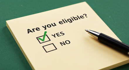 Eligibility Check Yes Box Ticked on Sticky Note with Green Background.