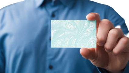 Close-up of a hand holding a light teal-colored business card with a marbled design.  The hand belongs to a person wearing a light blue shirt