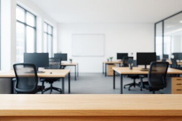 Fototapeta premium Modern open office interior with wooden desk in foreground and blurred workspace in background for branding or product display concept.
