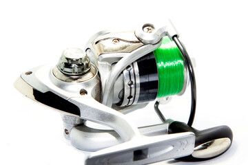Chrome and steel fishing reel equipment isolated on a white background