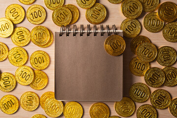 blank notebook or calendar with golden coins