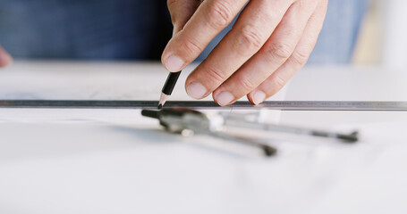 Architect, hands and ruler on paper for measurement, accuracy and building development. Floor planning, instrument and person drawing on blueprint for architecture, engineering and creativity
