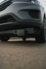 Fototapeta premium Modern Automobile: A close-up view of a modern vehicle showcases sleek design, highlighting the front end and undercarriage, focusing on the advanced technology and sturdy build.