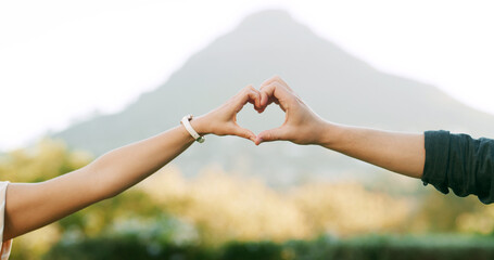 Love, heart and hands of couple in park for anniversary, bonding and relationship together on...