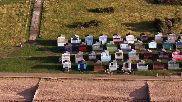 Colorful beach huts on Whitstable Beach, Kent, evoke a peaceful vibe