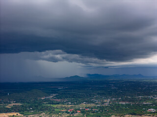 Obraz premium Aerial View of Rainfall and Thunderstorm Clouds Over Tropical Valley and Mountain Ranges