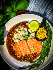 Fresh salmon salad with spicy Thai dressing, garnished with herbs, onions, and chili. Colorful and...