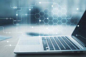 Laptop keyboard with hexagonal tech pattern and digital connections on a blurred office background representing modern digital technology concept.