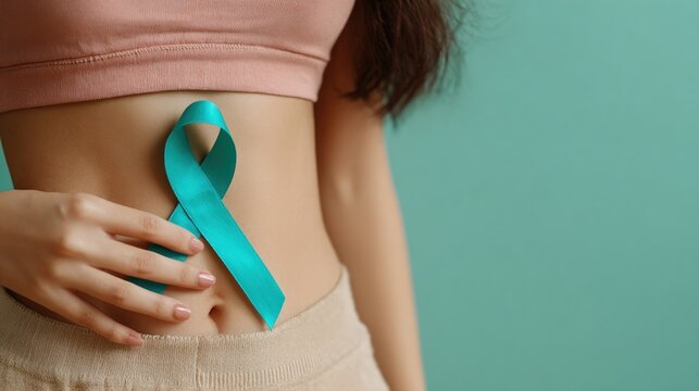 Woman showing teal awareness ribbon for polycystic ovary syndrome, sexual assault, cervical cancer, food allergies, and other health conditions