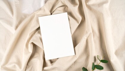 Flat lay mockup of blank magazine cover on neutral fabric texture for branding, editorial, and design presentation