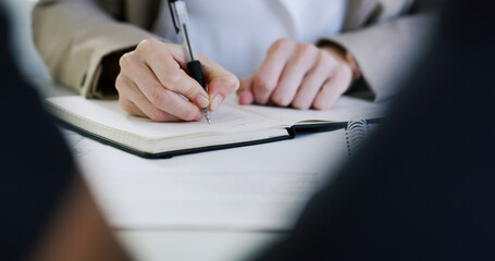 Hands, business woman and writing in notebook for finance report notes, workflow planner or...