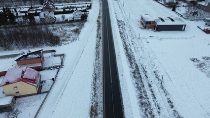 Rural winter road surrounded by snowy fields