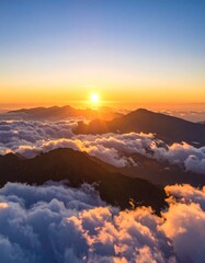 Obraz premium Sunrise over mountain peaks shrouded in clouds