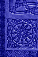 Close-up of an old embossed blue leather Celtic design journal cover background backdrop.