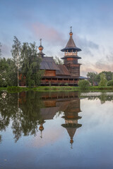 Wooden Orthodox church with reflection in pond, Blagoveshchenye village, Russia