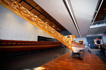 Ornately Decorated Historic Boat with Golden Detailing on Display in Museum
