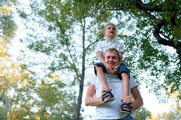 Fototapeta premium Father and Son Outdoors Bonding in a Green Forest Setting
